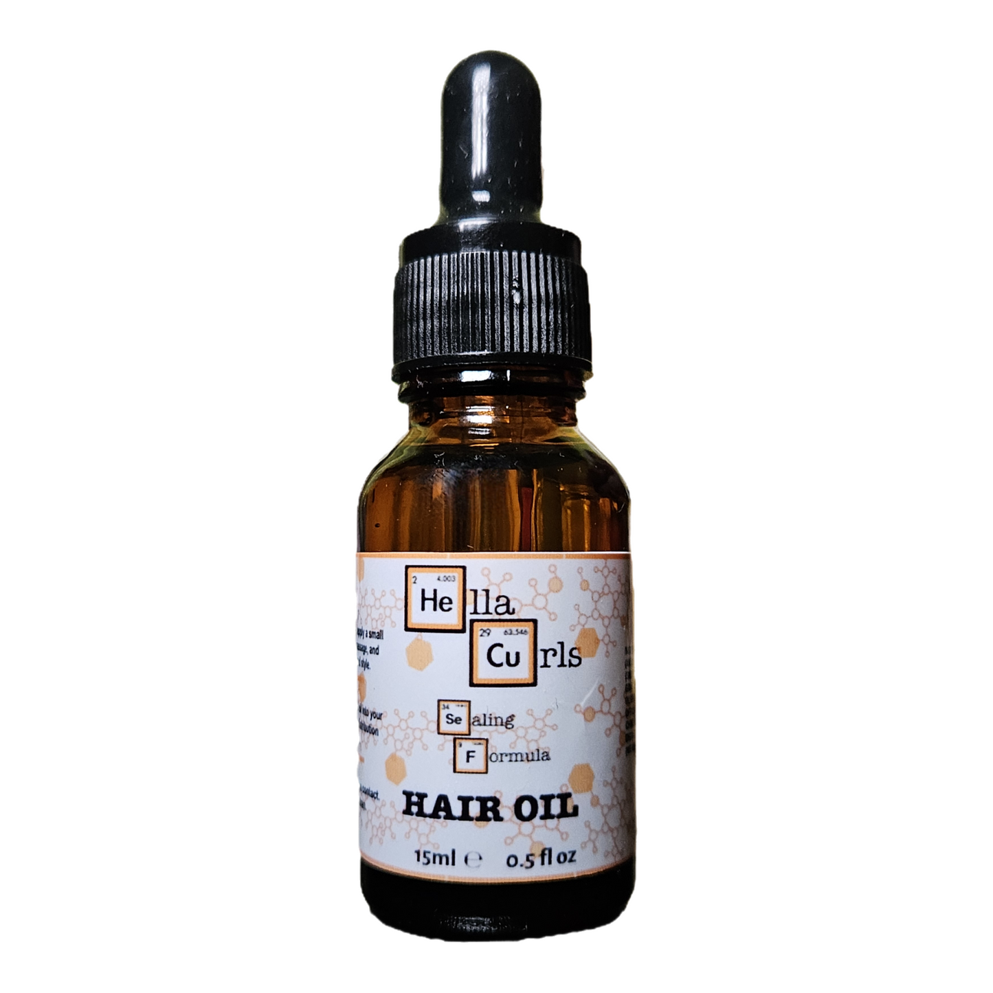 Bottle of Hella Curls hair oil with a dropper on a white background