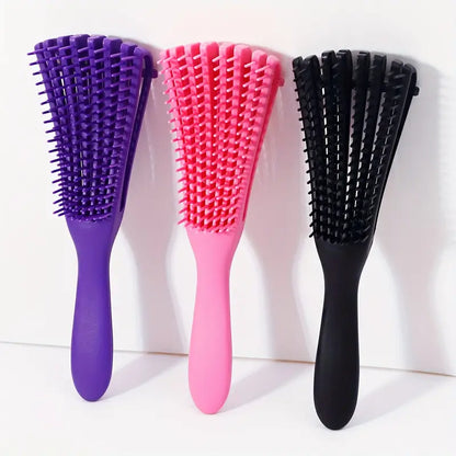 Three hairbrushes in purple, pink, and black on a white background