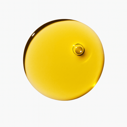 Drop of golden hair oil on white background.
